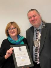 Penny Hyde receiving the reward from the Mayor, Cllr Alex Stennett.